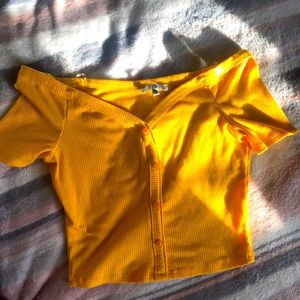 Yellow crop top, medium sized and the brand name is iris